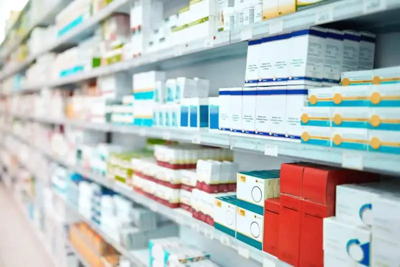 A well stocked pharmacy with a variety of medications and eye care products.